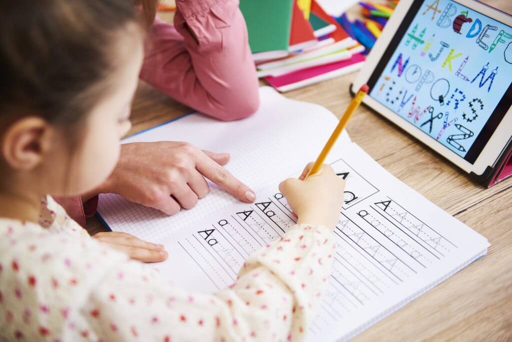 Close up of mother helping her child with homework